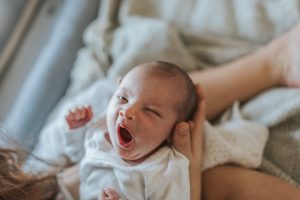 An image of a yawning baby taken by Melanie Grace