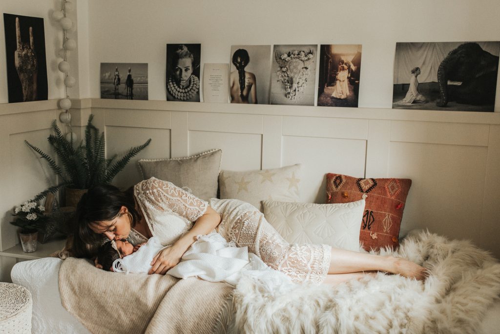 An image of a woman embracing a child taken by Melanie Grace